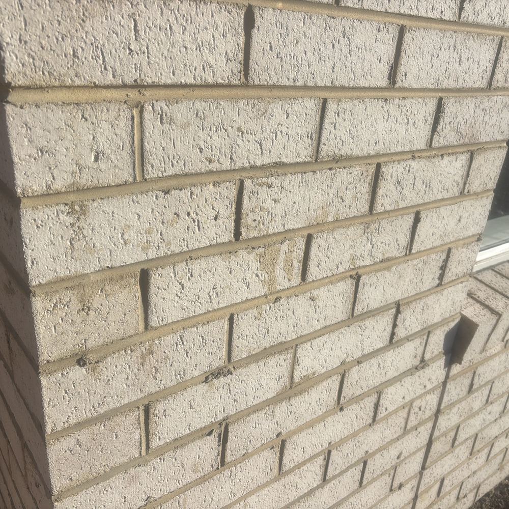 Brickwork still to be acid washed to clear the mortar stains, found during a fixing inspection in Maddingley