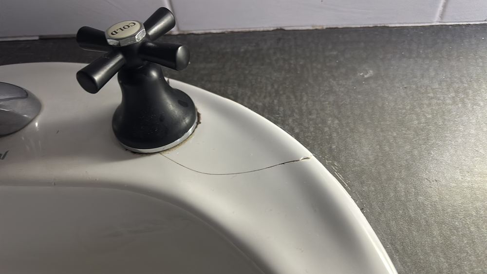Sink surface marked and damaged, needing repair or replacement, found during a pre-purchase inspection in Darley